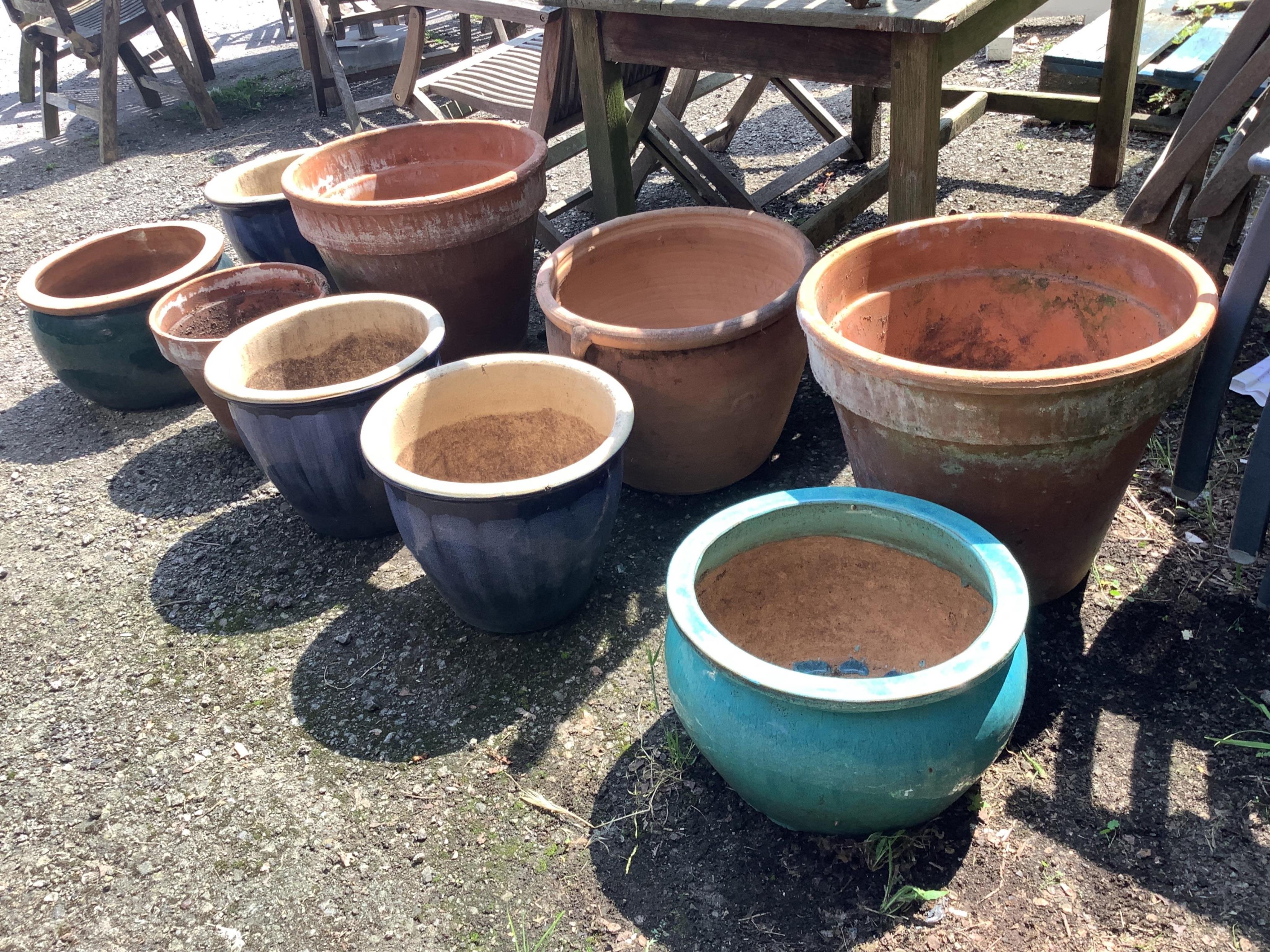 A pair of circular terracotta garden planters, diameter 49cm, height 41cm, together with seven other circular planters. Condition - fair